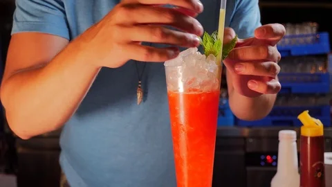 Bartender decorating cocktails in a bar Stock Footage 93324544