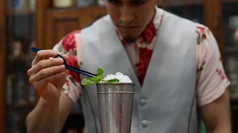 Bartender decorating mint julep cocktail in metal glass with ice. Stock Footage 145019804
