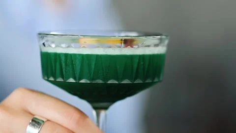 Bartender demonstrates a beautiful green refreshing cocktail Stock Footage 244806006