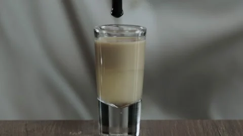 The bartender drips a drop of grenadine syrup from a drinking straw. Close up Stock Footage 132742678