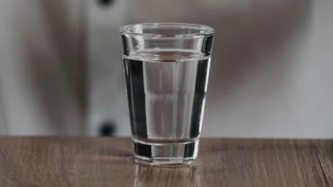 The bartender drips a drop of irish cream from a drinking straw to glass with sa Stock Footage 132761596