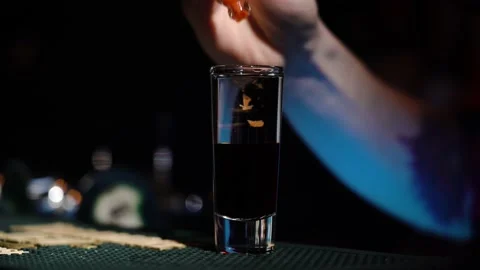 Bartender drips hot sauce into spirits shot at bar. Stock Footage 149240561