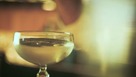 Bartender dropping olive in cocktail Stock Footage 103862521