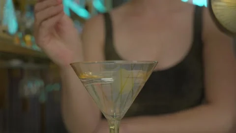 Bartender drops olive in martini slow motion Stock Footage 275188012