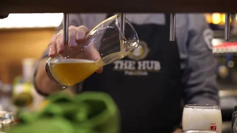 Bartender fill Super Slow Motion Shot of Rippling Fresh Beer Wave into glas.. Stock Footage 265768008