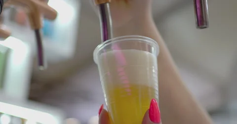 Bartender filling plastic cup with fresh draft beer Stock Footage 302345893