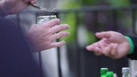 Bartender gives a man a mixed drink outside Video stock 78108399