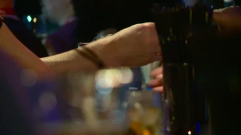 The bartender gives out two glasses of beer to the bar customer telephoto Stock Footage 155983980