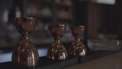 A bartender grabs a copper measuring cup to make his cocktail in slow motion Stock Footage 135451938