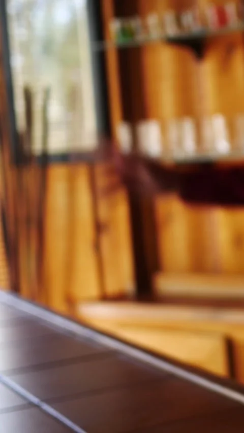 Bartender hands a Glass of Whiskey to Off-Camera Customer in Bar - Vertical Vidéo 332315554