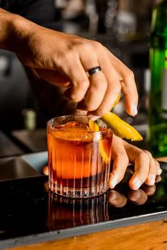 Bartender Hands Making a Perfect Drink on Bar Gin Tonic Negroni Caipirinha Mosco Stock Photos