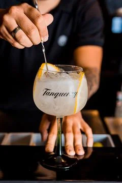 Bartender Hands Making a Perfect Drink on Bar Gin Tonic Negroni Caipirinha Mosco Stock Photos