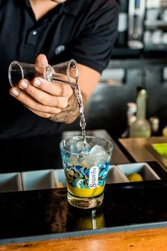 Bartender Hands Making a Perfect Drink on Bar Gin Tonic Negroni Caipirinha Mosco Stock Photos
