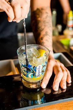 Bartender Hands Making a Perfect Drink on Bar Gin Tonic Negroni Caipirinha Mosco Stock Photos