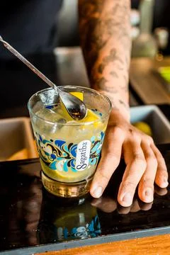 Bartender Hands Making a Perfect Drink on Bar Gin Tonic Negroni Caipirinha Mosco Stock Photos