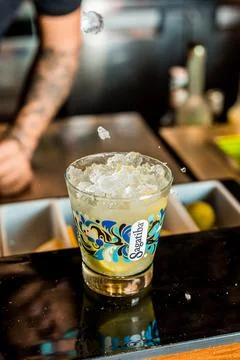 Bartender Hands Making a Perfect Drink on Bar Gin Tonic Negroni Caipirinha Mosco Stock Photos