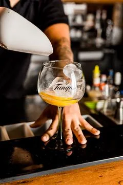 Bartender Hands Making a Perfect Drink on Bar Gin Tonic Negroni Caipirinha Mosco Stock Photos