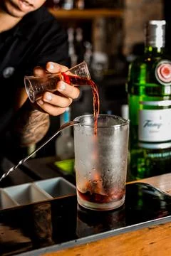 Bartender Hands Making a Perfect Drink on Bar Gin Tonic Negroni Caipirinha Mosco Stock Photos