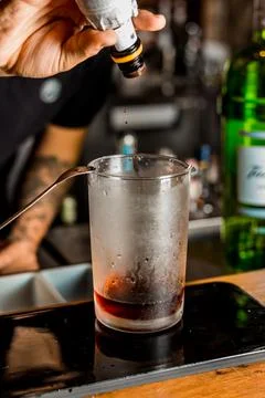 Bartender Hands Making a Perfect Drink on Bar Gin Tonic Negroni Caipirinha Mosco Stock Photos