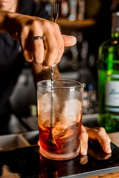 Bartender Hands Making a Perfect Drink on Bar Gin Tonic Negroni Caipirinha Mosco Stock Photos