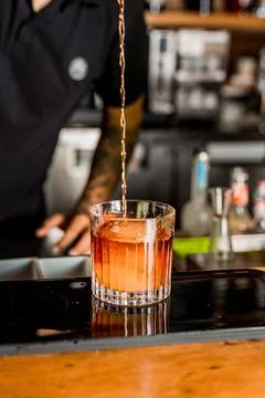 Bartender Hands Making a Perfect Drink on Bar Gin Tonic Negroni Caipirinha Mosco Stock Photos