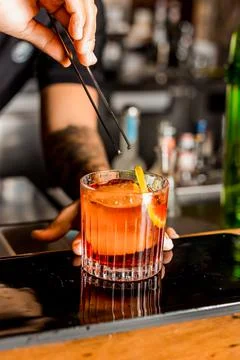 Bartender Hands Making a Perfect Drink on Bar Gin Tonic Negroni Caipirinha Mosco Foto stock