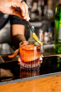 Bartender Hands Making a Perfect Drink on Bar Gin Tonic Negroni Caipirinha Mosco Stock Photos