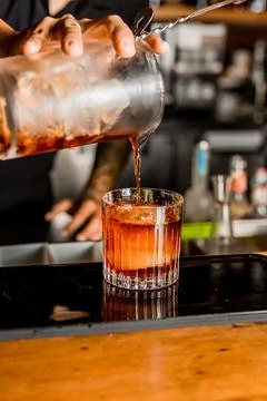 Bartender Hands Making a Perfect Drink on Bar Gin Tonic Negroni Caipirinha Mosco Stock Photos