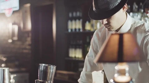 Bartender in hat is preparing cocktail in bar Stock Footage 75231994