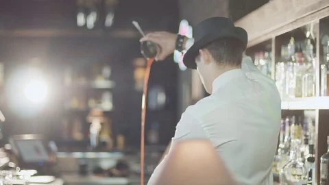 Bartender in hat is preparing cocktail in bar Stock Footage 75241364