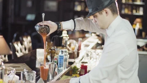 Bartender in hat is preparing cocktail in bar Stock Footage 75241467