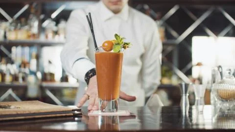 Bartender in hat is preparing cocktail in bar Stock Photos