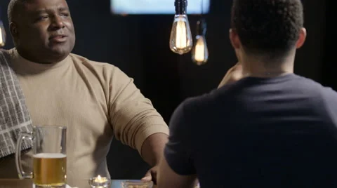 Bartender having a lively conversation with a customer Stock Footage 62933487