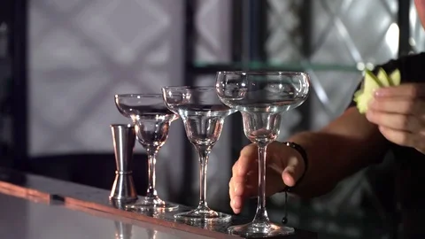 The bartender inserts a fruit sliced into a glass Stock-Footage 85132706