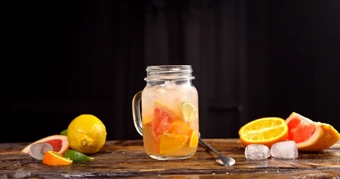 Bartender inserts a straw into a juicy fruit cocktail Stock Footage 113084506
