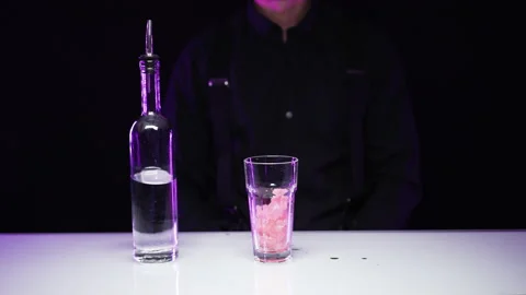Bartender learns to make a cocktail. The drink is poured on the table Stock Footage 168832394