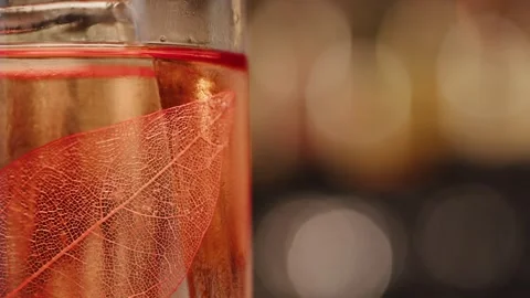 Bartender make a cocktail for guest in the bar. Pink icy alcohol drink with Stock Footage 253896249