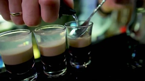 Bartender makes a B-52 cocktail at a nightclub bar Stock Footage 134939861