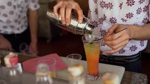 The bartender makes a bright multi-colored cocktail Stock Footage 151423867