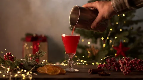 The bartender makes Christmas cocktails. A raspberry drink from a shaker is Stock Footage 223687343