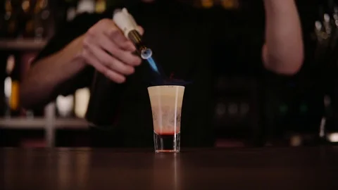 The bartender makes a cocktail of fire. Hiroshima cocktail. The barman ignites Stock Footage 97825555