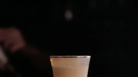 The bartender makes a cocktail of fire. Hiroshima cocktail. The barman ignites Stock Footage 97826473