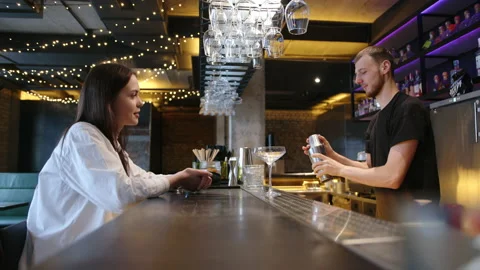 The bartender makes a cocktail to the guest in the restaurant at the bar. slow Stock Footage 236964987