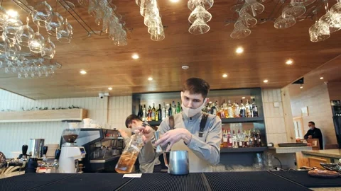A bartender makes a cocktail over the bar counter Stock Footage 149898032