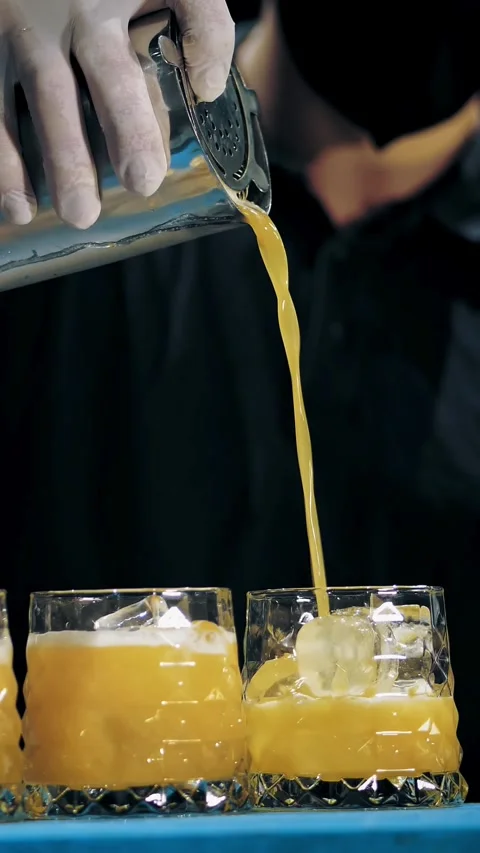 Bartender makes cocktails. close-up. the bartender is pouring cocktail into Stock Footage 320610158