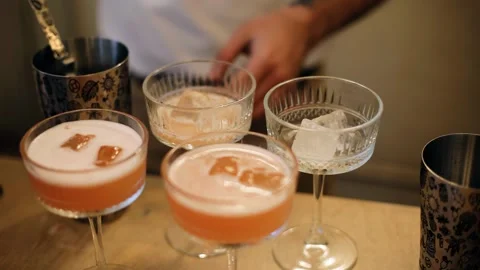 The bartender makes cocktails standing at the bar Stock Footage 329372636