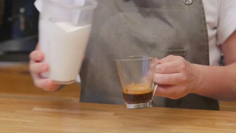The bartender makes coffee with cream and caramel. Stock Footage 82480450