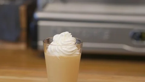 The bartender makes coffee with cream and caramel. Stock Footage 82480510