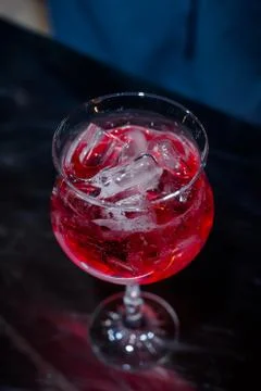 The bartender makes a red cocktail. Blue dark background Stock Photos