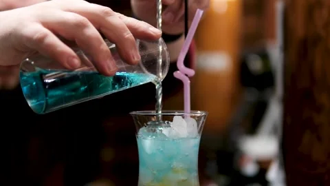 The bartender makes a shot at the bar. Making a Hiroshima cocktail in a Stock Footage 323532154